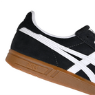 Detail of Black suede Asics Skateboarding Gel-Vickka Pro skateboard sneaker with a gum sole and white Onitsuka branding on a white background