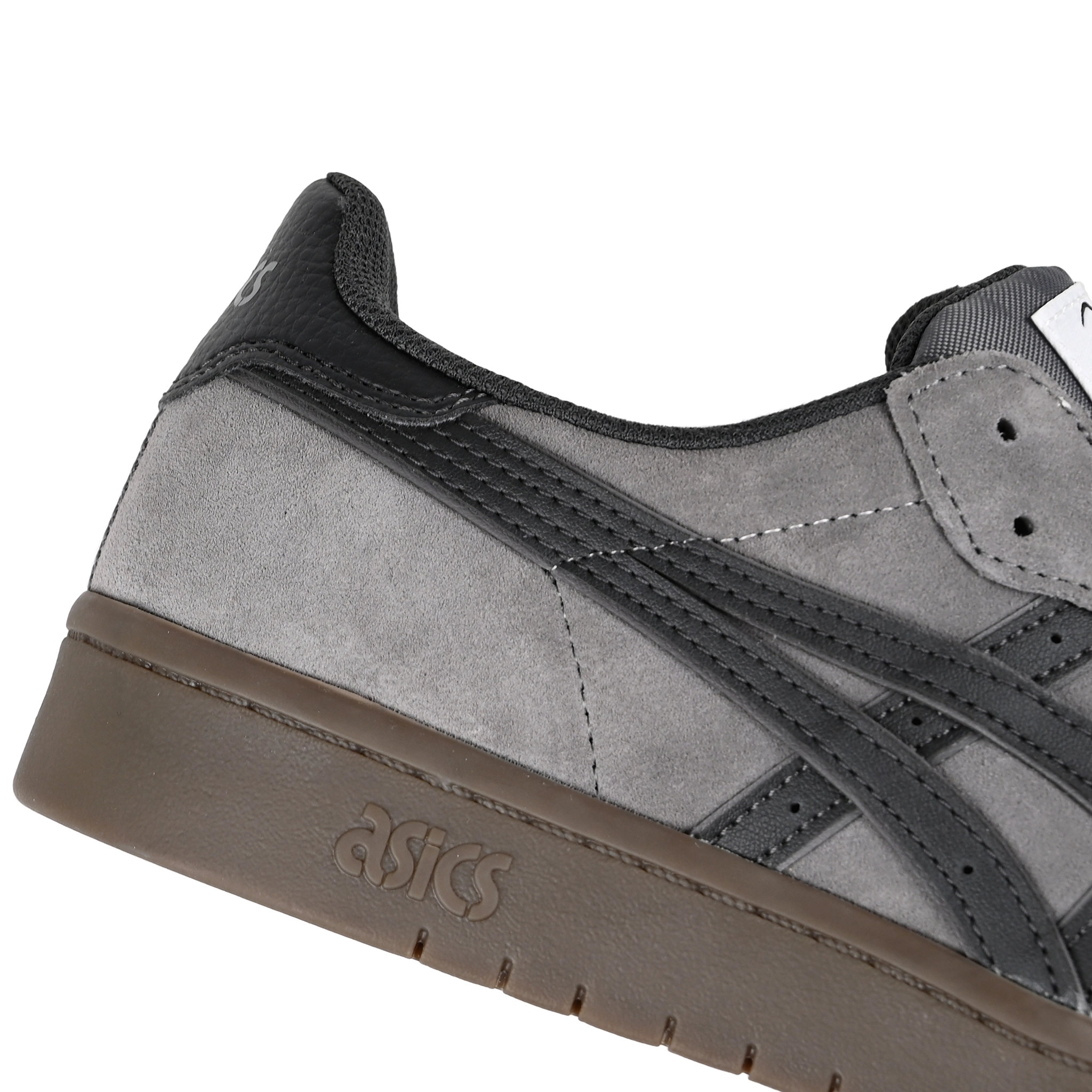 Close up of Carbon and graphite grey ASICS Japan Pro skateboard sneaker with 'Onitsuka' branding on a white background