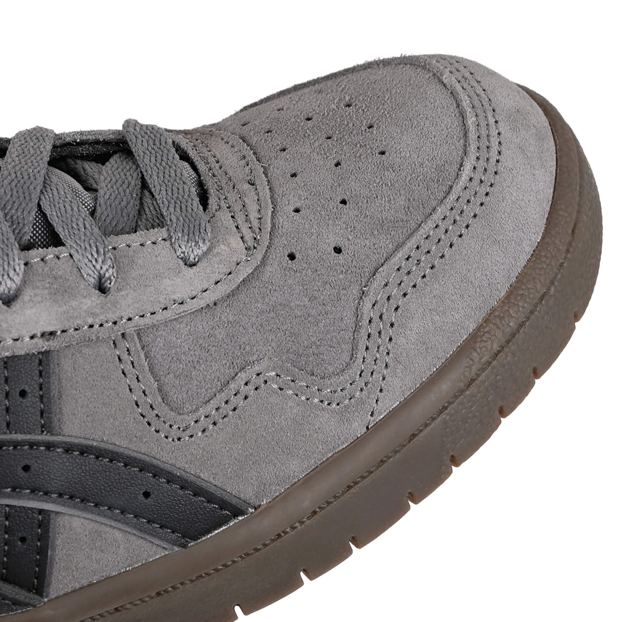 Toe box of Carbon and graphite grey ASICS Japan Pro skateboard sneaker with 'Onitsuka' branding on a white background