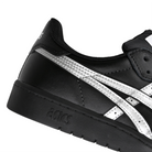 Detail of Black leather Asics Skateboarding Japan Pro skateboard sneaker with Pure Silver 'Onitsuka' branding on a white background