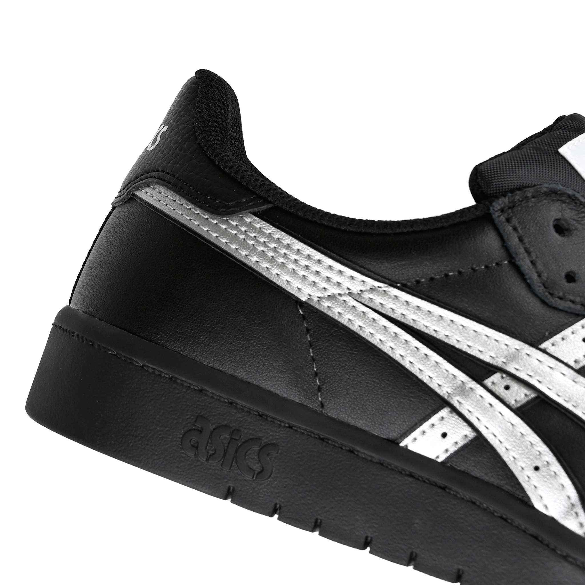 Detail of Black leather Asics Skateboarding Japan Pro skateboard sneaker with Pure Silver 'Onitsuka' branding on a white background