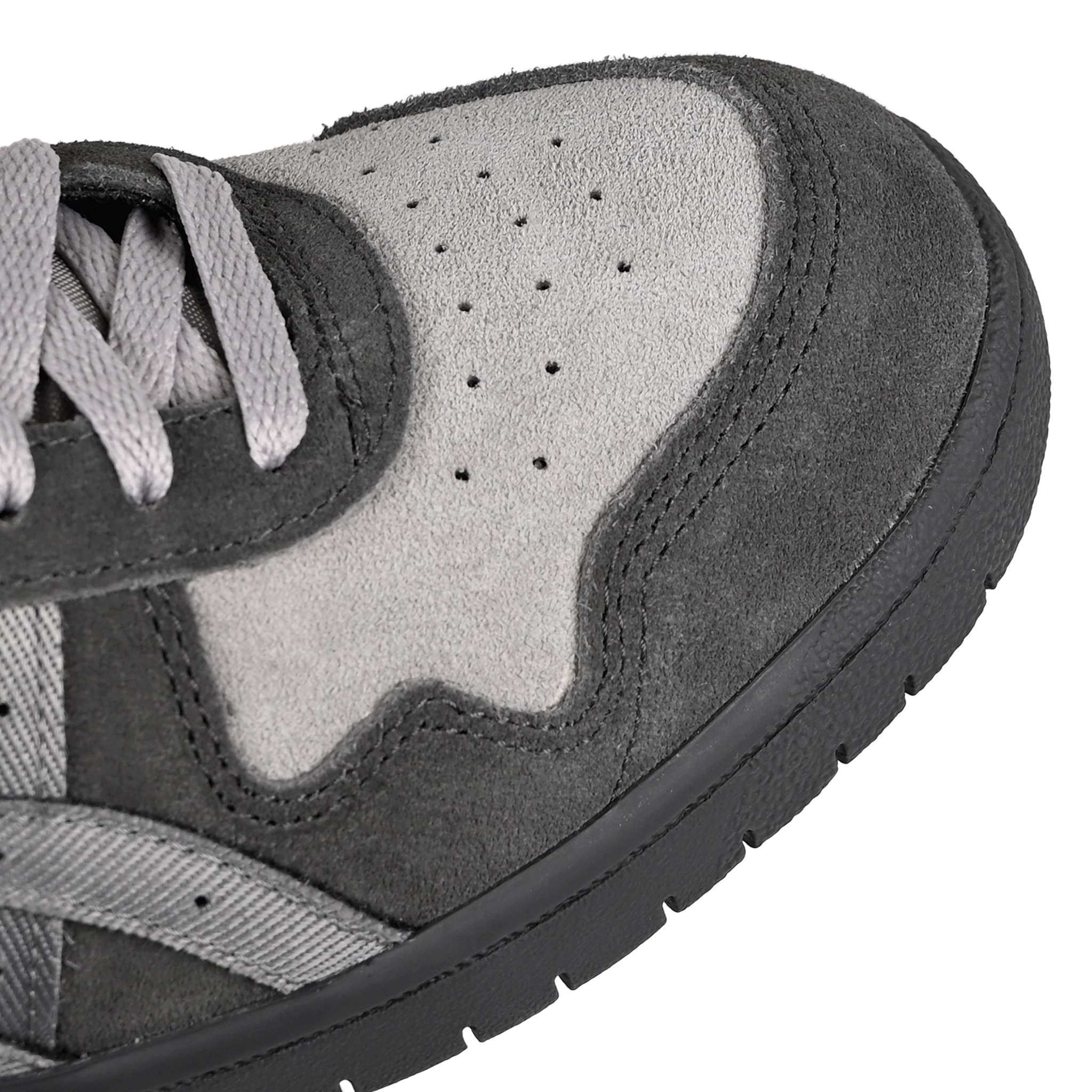 Toe box of Graphite grey and clay grey ASICS Japan Mid Pro skateboard sneaker with 'Onitsuka' branding on a white backgorund