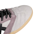 Toe box of Oyster grey and black ASICS Skateboarding x Late Nite Stars Leggerezza FB Pro skateboarding sneaker with 'Onitsuka' branding on a white background