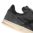 Heel detail of Graphite Grey Asics Skateboarding Leggerezza FB men's skateboard sneaker with Onitsuka branding on a white background