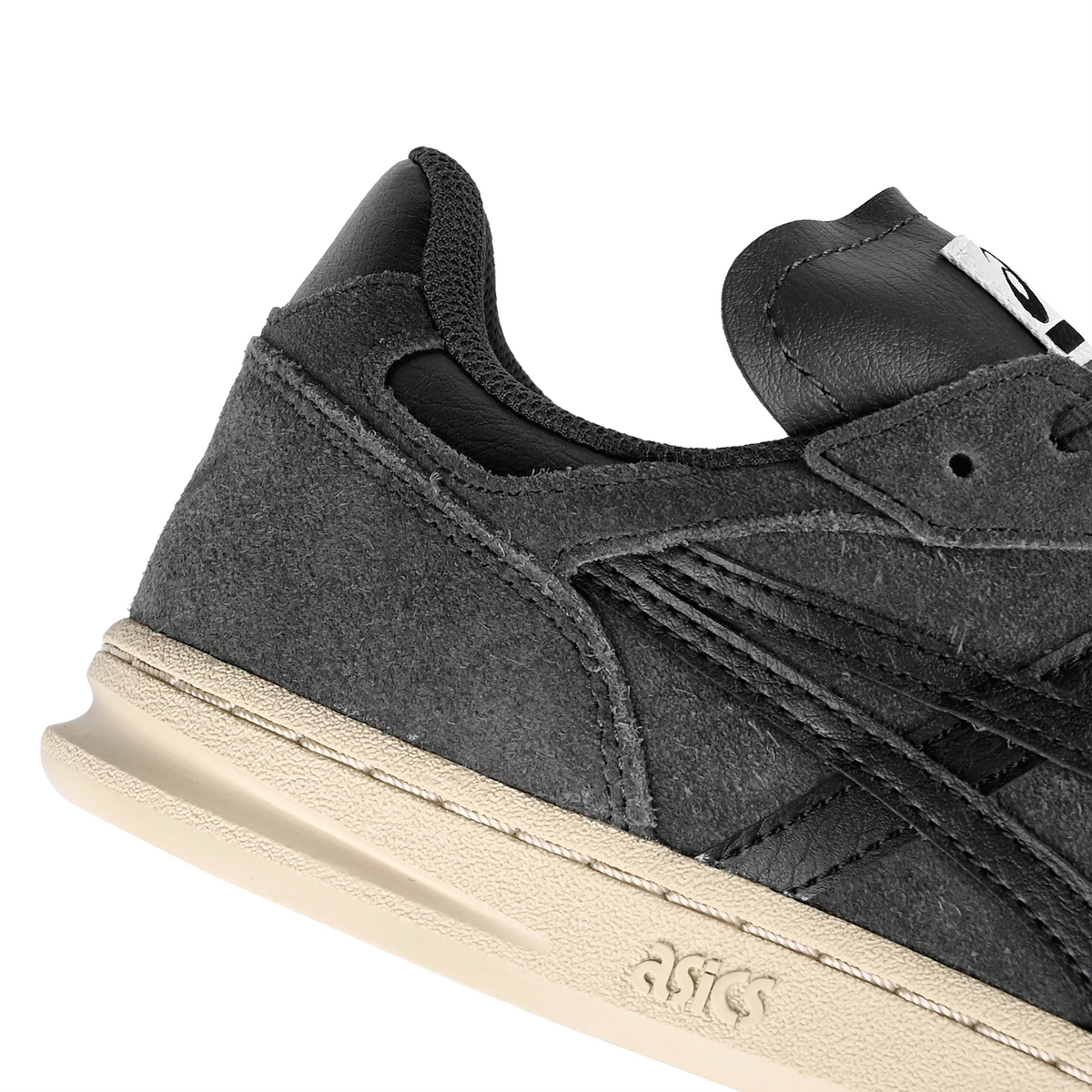 Heel detail of Graphite Grey Asics Skateboarding Leggerezza FB men's skateboard sneaker with Onitsuka branding on a white background