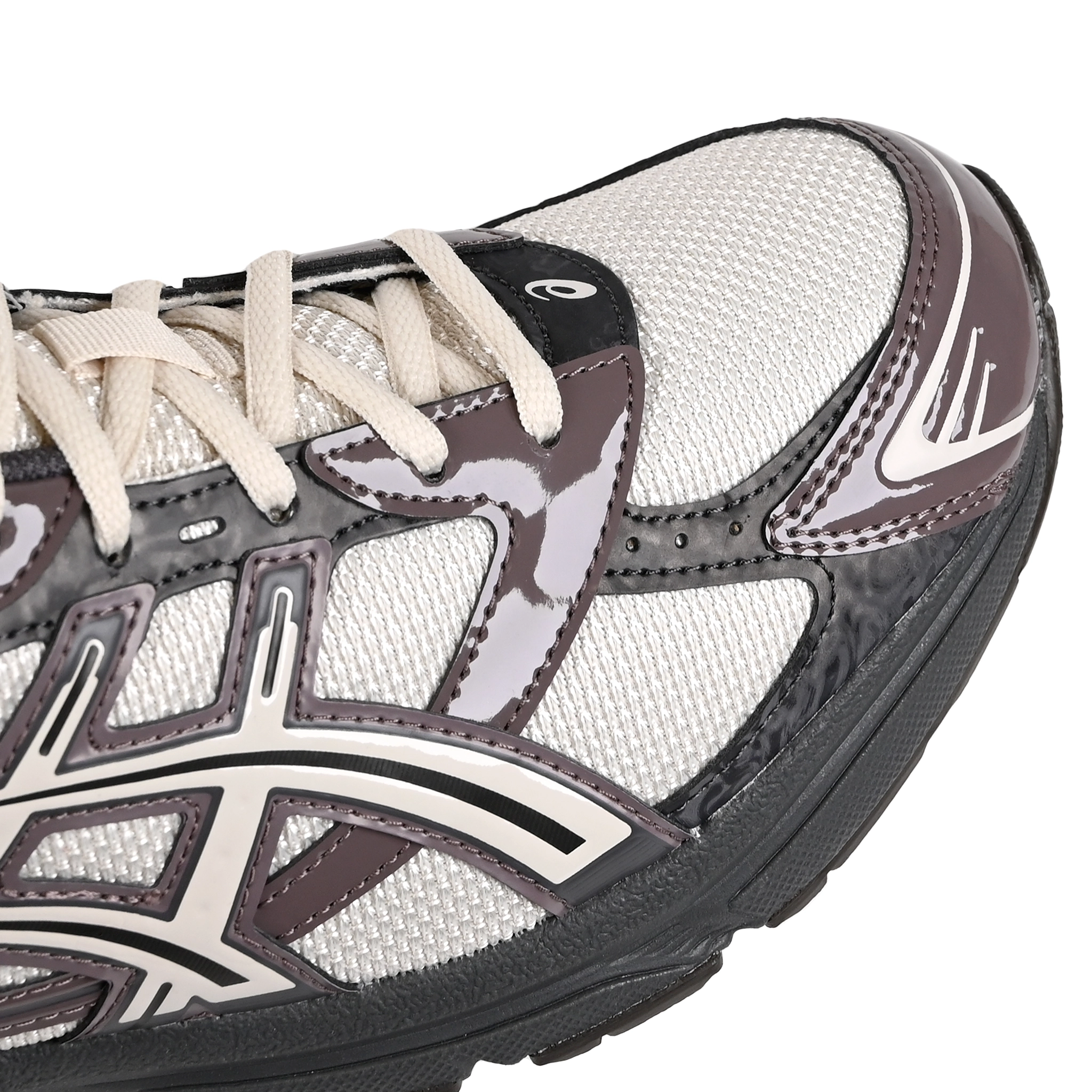Toe box of Oatmeal and obsidian grey Asics Sportstyle GEL-1130 men's lifestyle sneaker with 'Onitsuka' branding on a white background