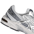 Close up of Glacier grey and pure silver ASICS sportstyle GEL-1130 sneaker with 'Onitsuka' branding on a white background
