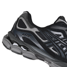 Detail of Graphite grey and black Asics Sportstyle GEL-NYC mens lifestyle sneaker with 'Onitsuka' branding on a white background