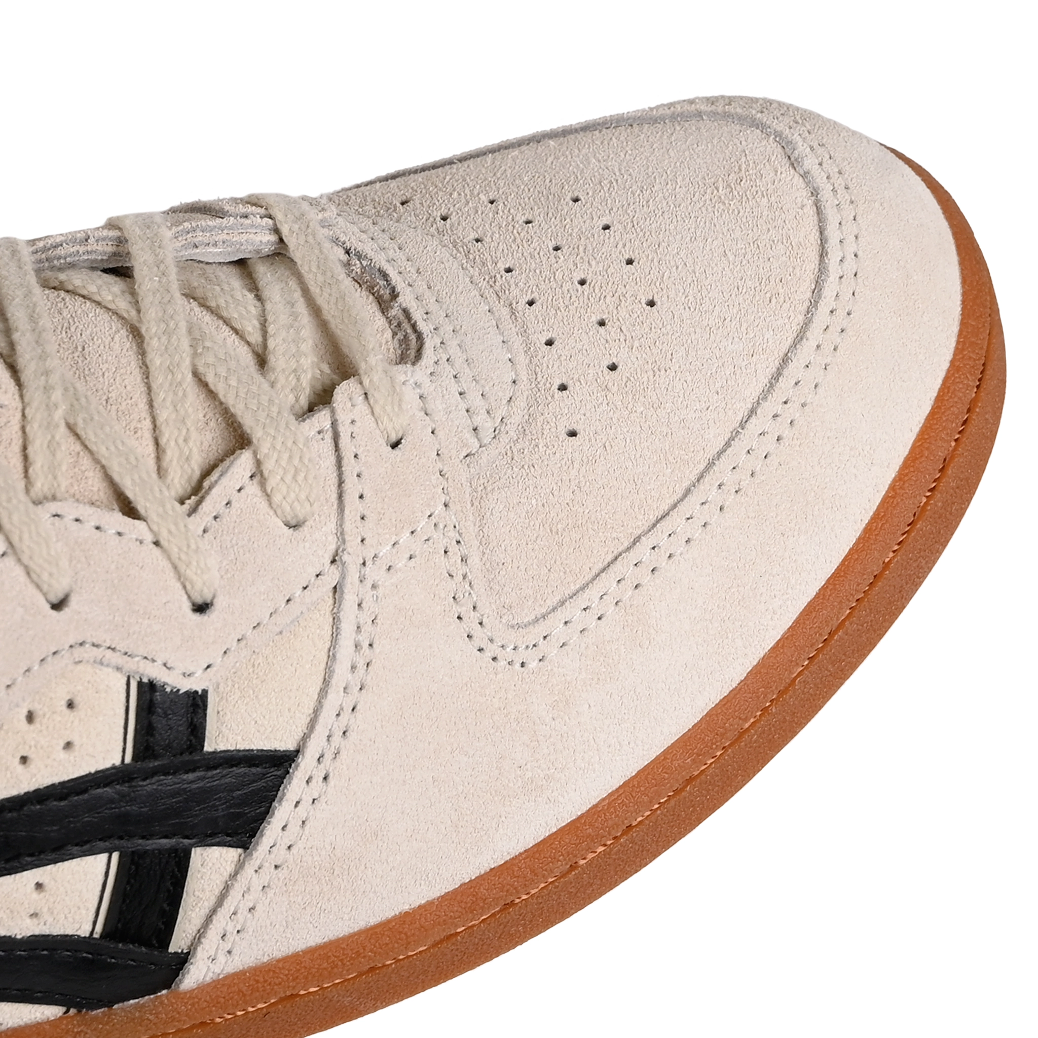 Toe box of Oatmeal and black Asics Sportstyle Skyhand OG lifestyle sneaker with 'Onitsuka' branding on a white background