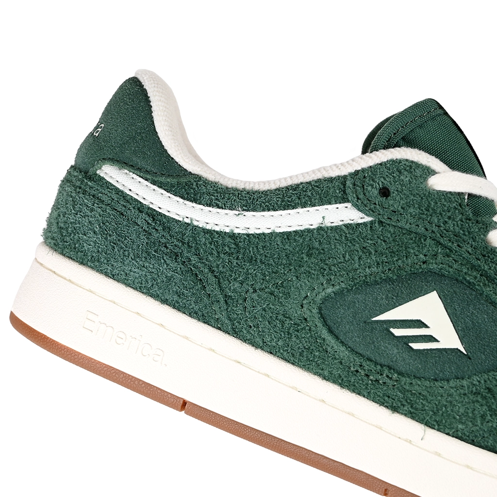 A close up of Emerica Skateboarding KSL III green sneaker with white laces on a white background