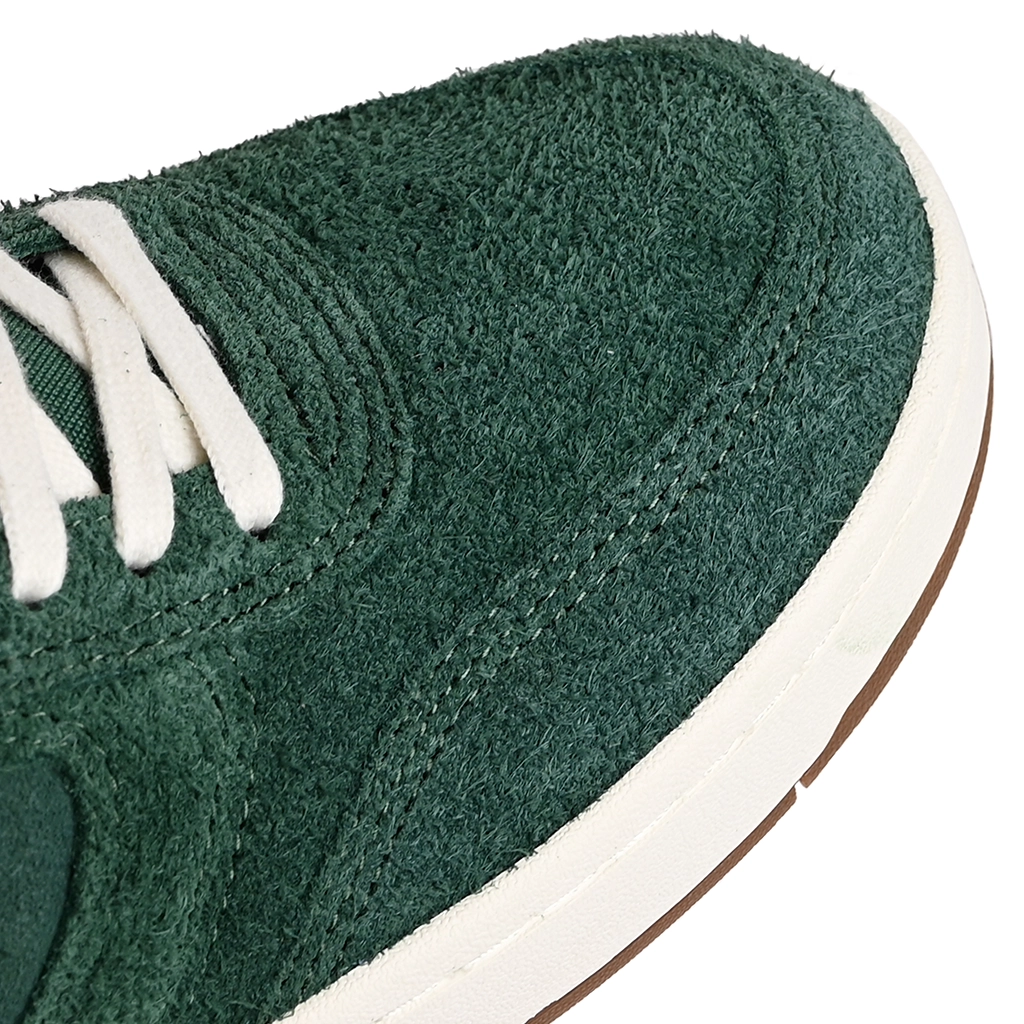 A close up of Emerica Skateboarding KSL III green sneakers with white laces on a white background