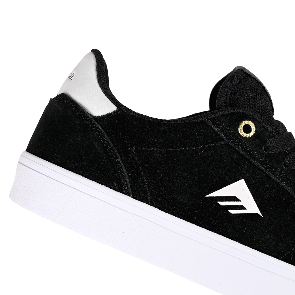 Close up of Emerica Skateboarding MOCA black sneaker with white sole and brand logo on a white background