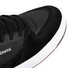 Close up of Black Emerica Skateboarding Mute sneaker with white sole on a white background