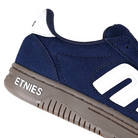 Close up of of navy gum Etnies Skateboarding Locut men's skateboard sneakers with brand logo on a white background
