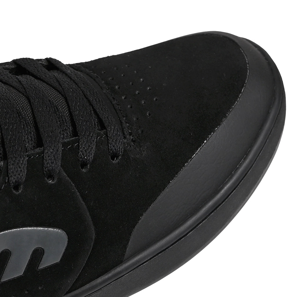 Close up of Etnies Marana black skateboarding shoe showing fused rubber toe cap