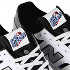 Tongue tag close up of white blue black New Balance Numeric x Gas Giants NM306 Cup Jamie Foy pro model men's skateboard sneakers on a white background
