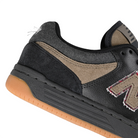 Close up of Black and arid stone New Balance Numeric x No-Comply NM480 skateboard sneaker with a denim heel collar on a white background