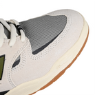 Toe box of Sea Salt New Balance Numeric NM1010 Tiago Lemos pro model skateboard sneaker with Dark Olivine branding on a white background