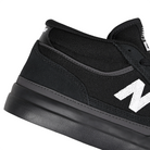Close up of Black and white New Balance Numeric NM417 Franky Villani pro model mid top men's skateboard sneaker on a white background