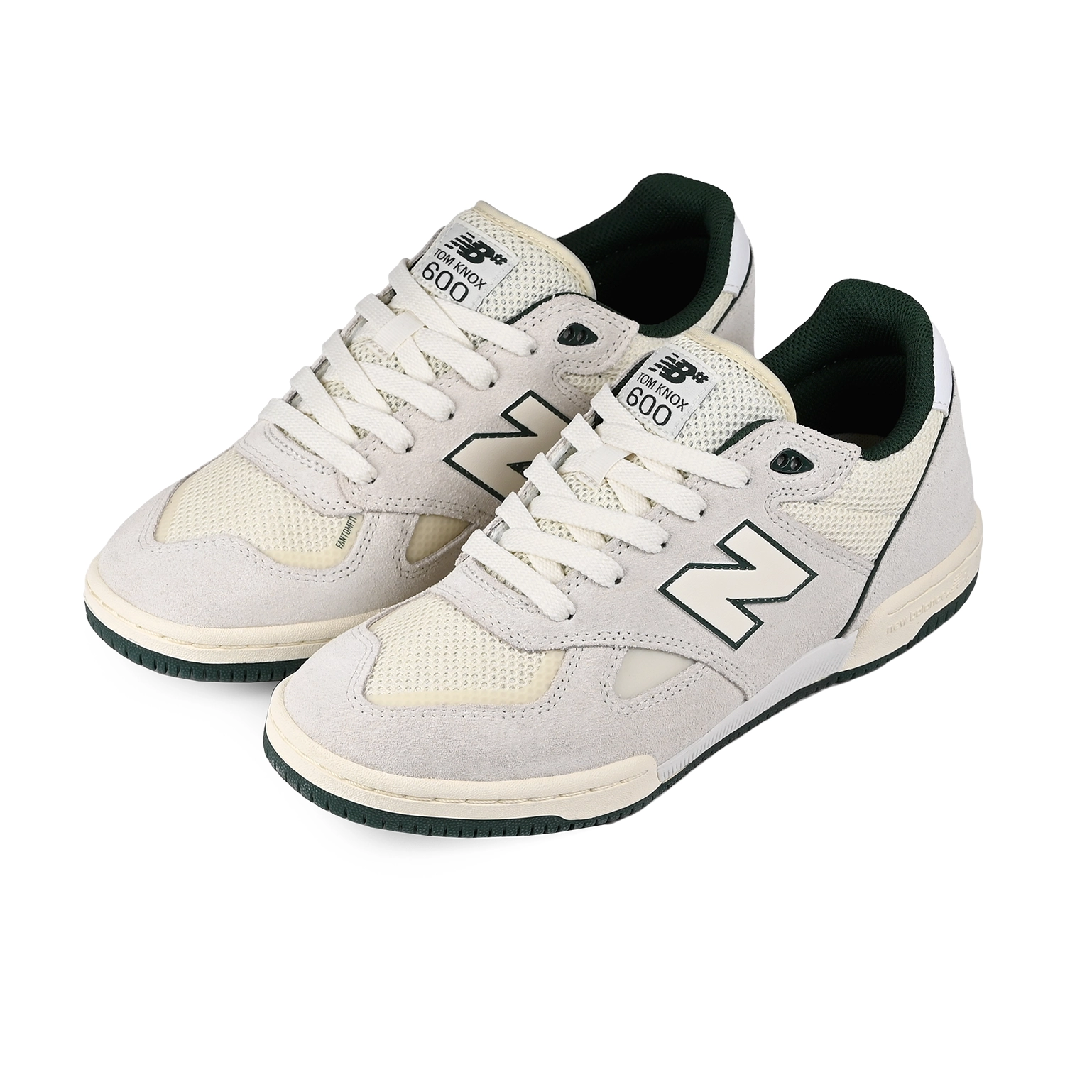 A pair of White and green New Balance Numeric NM600 Tom Knox pro model men's skateboard sneakers on a white background