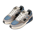 A pair of New Balance Andrew Reynolds NM933 sneakers in gray and blue with New Balance logo on a white background