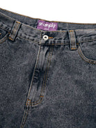 Close up of Black Wash No-Comply Loose Fit denim jeans on a white background