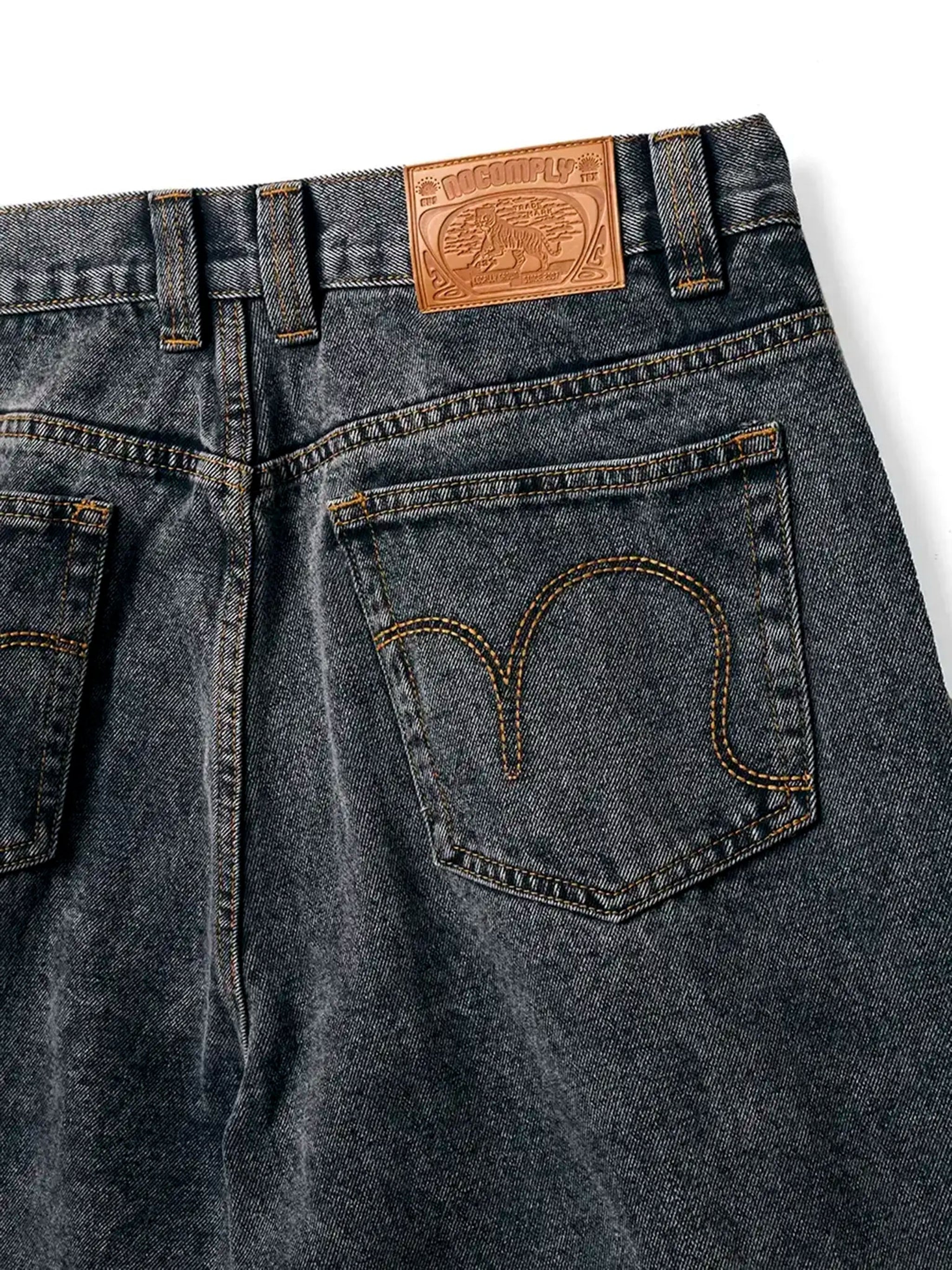Close up of back tag Black Wash No-Comply Loose Fit denim jeans on a white background
