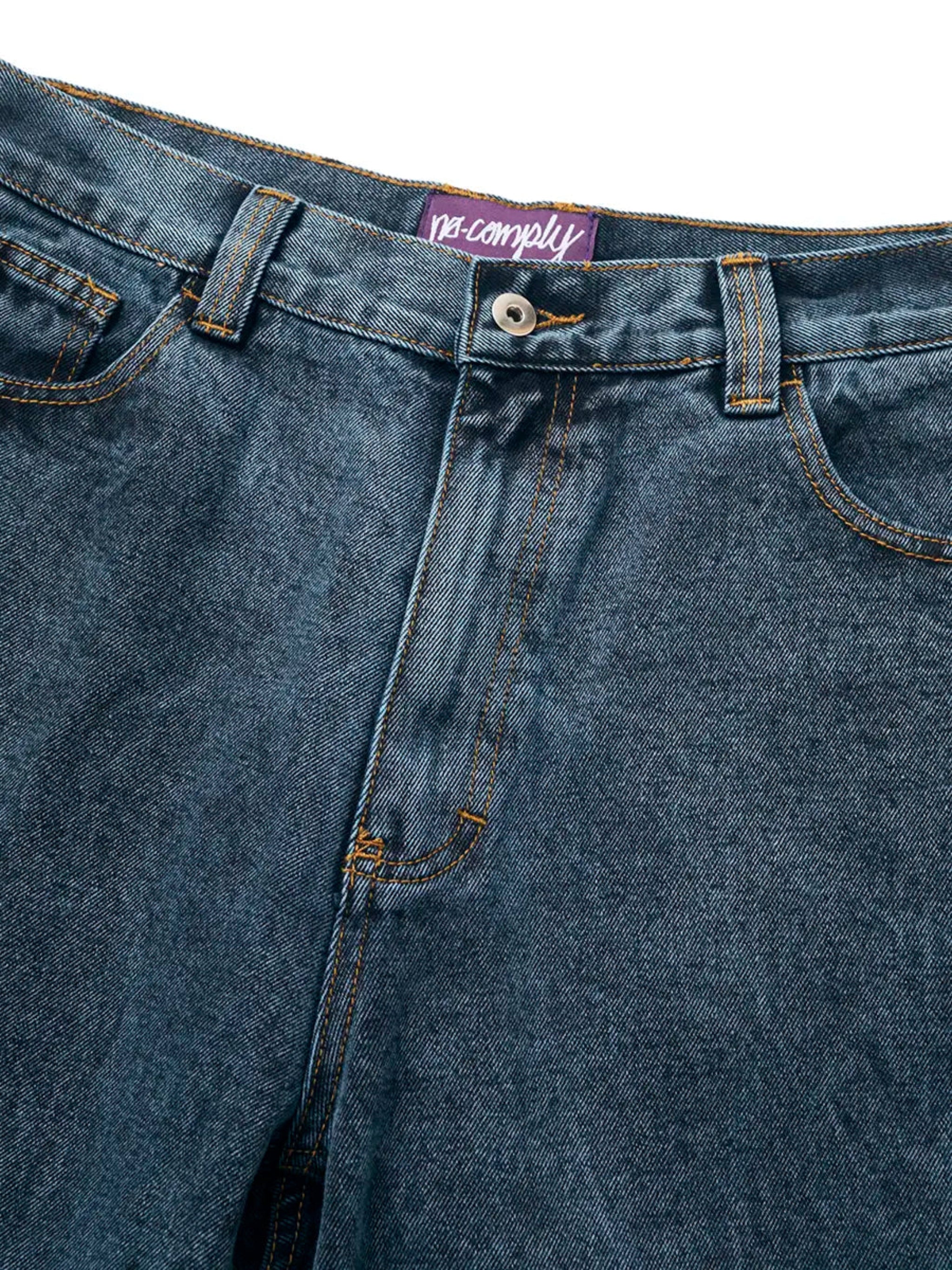 Close up front view of Teal Wash No-Comply Loose Fit denim jeans on a white background