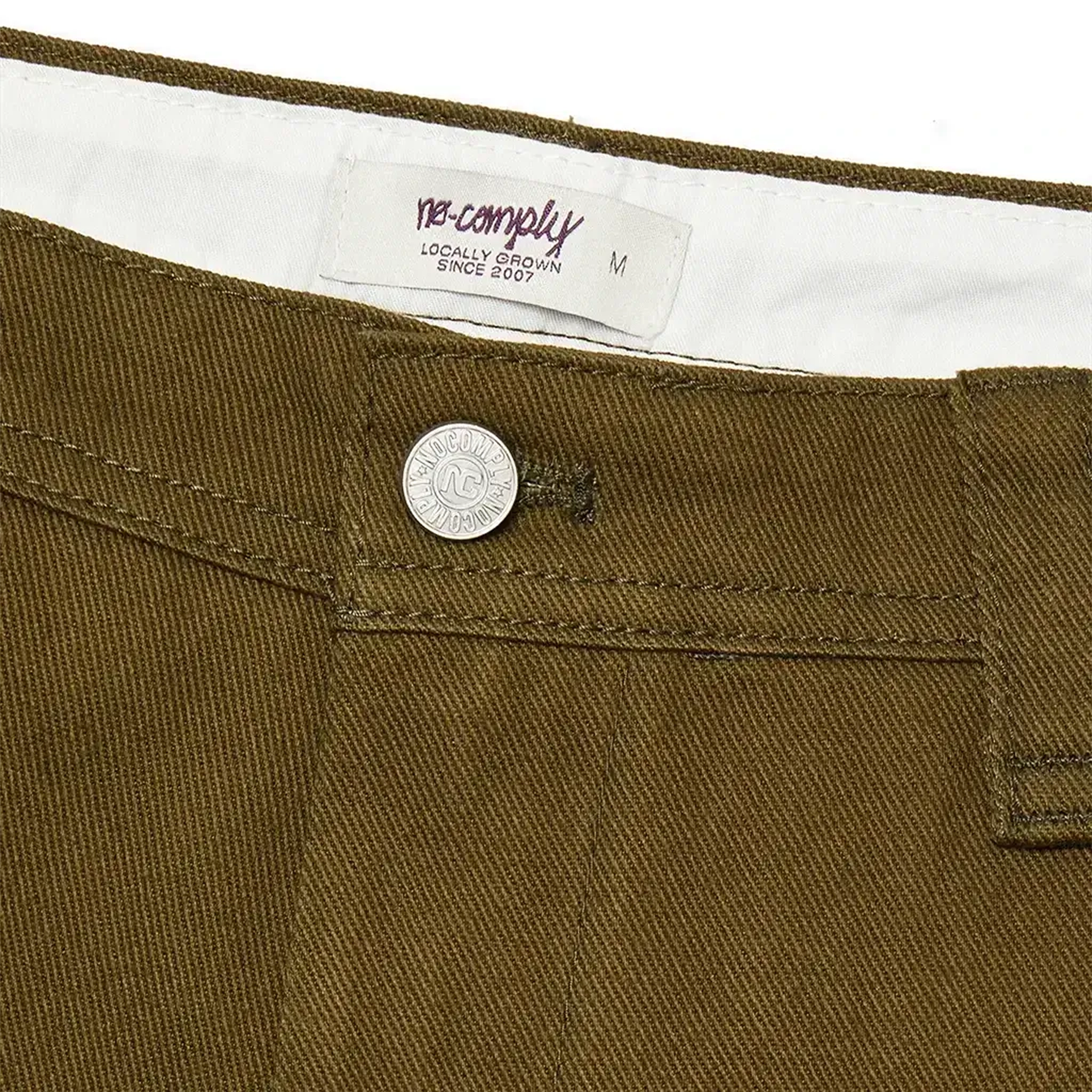 Custom button closure of Olive green No-Comply Skate Chino men's skateboard pant on a white background