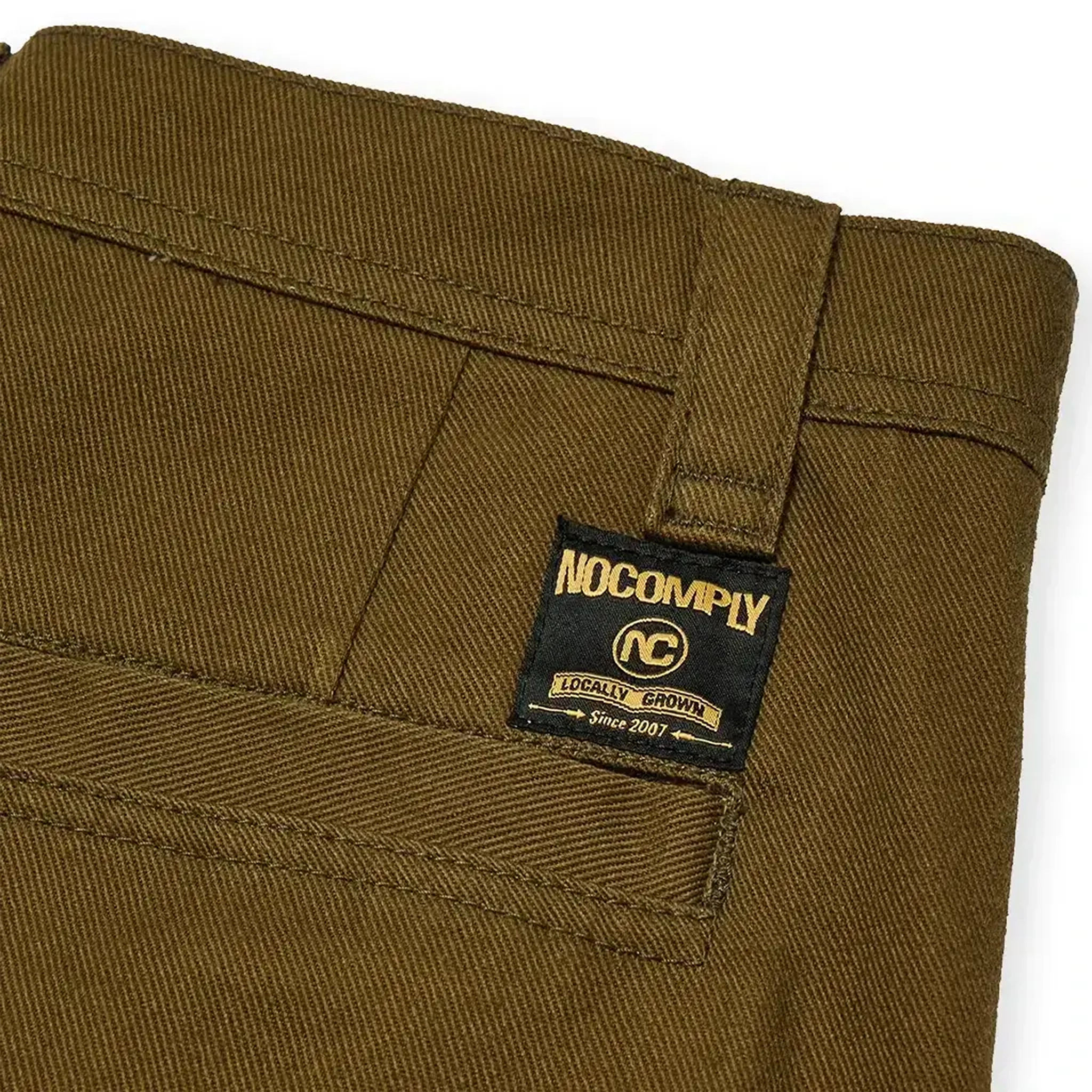 Close up of Olive green No-Comply Skate Chino men's skateboard pant on a white background