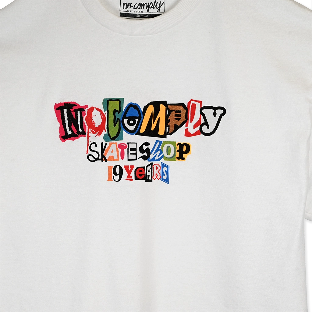 White No-Comply t-shirt with colorful text design branding on a white background