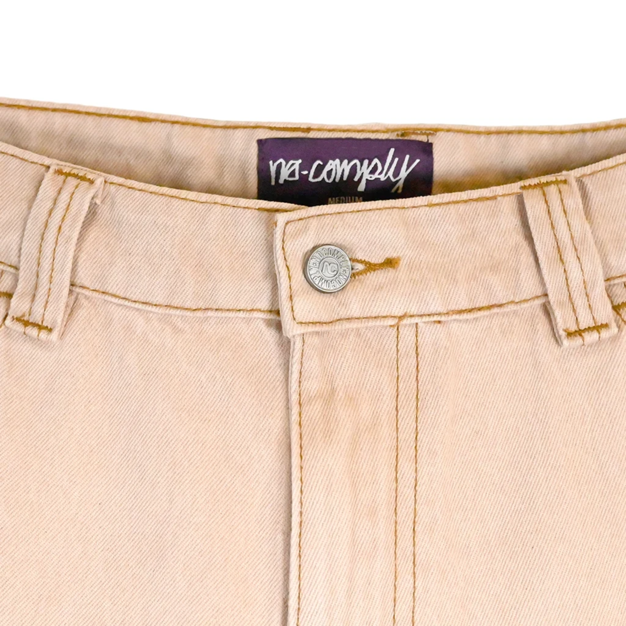 Close up front view of Beige Wash No-Comply Loose Fit denim jeans on a white background