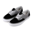 A pair of Vans Skateboarding black and gray Era sneakers with white laces on a white background