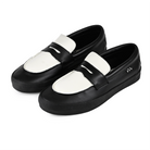 A pair of Black leather Vans Skateboarding Skate Loafer skateboard sneaker on a white background