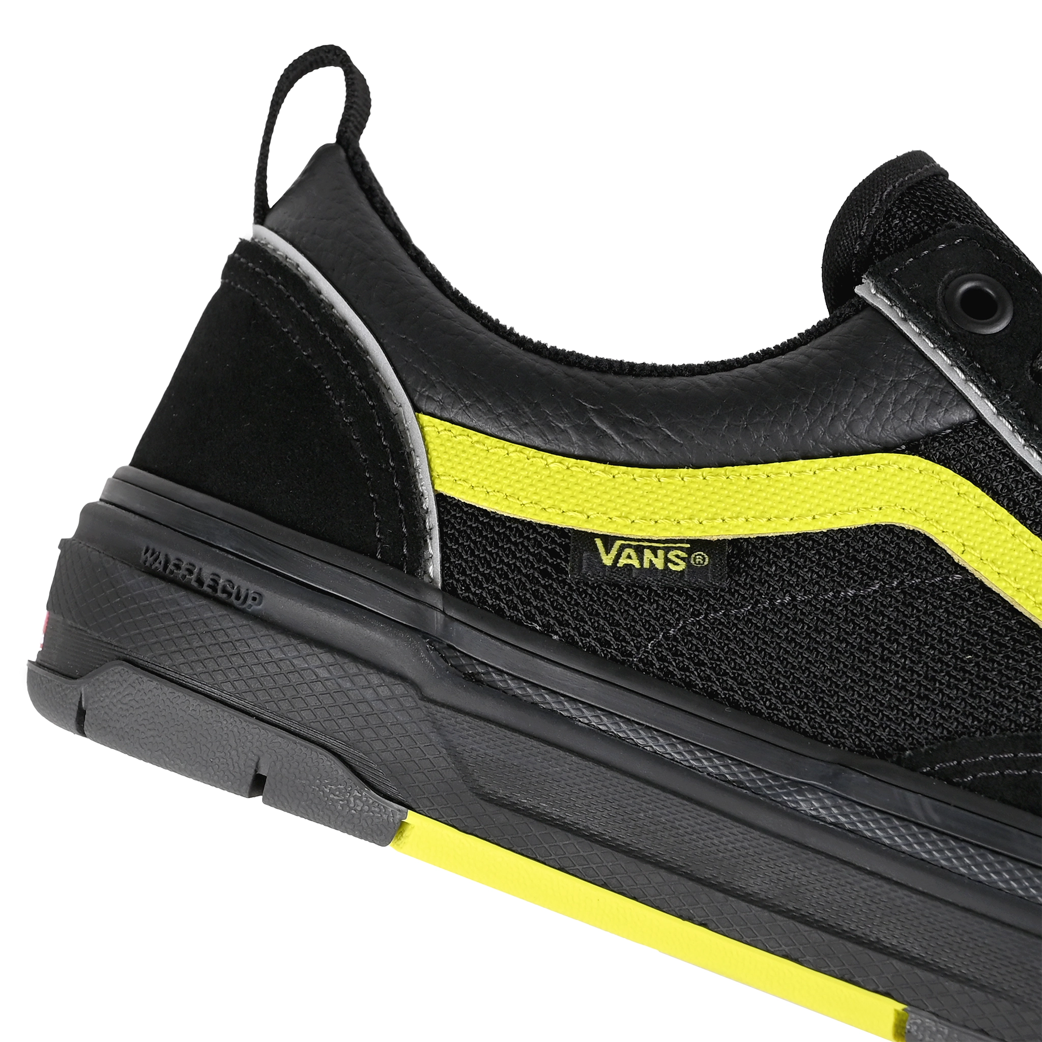 Detail of Black reflective Vans Skateboarding Skate Old Skool Wafflecup skateboard sneaker with Lime Jazz stripe on a white background.
